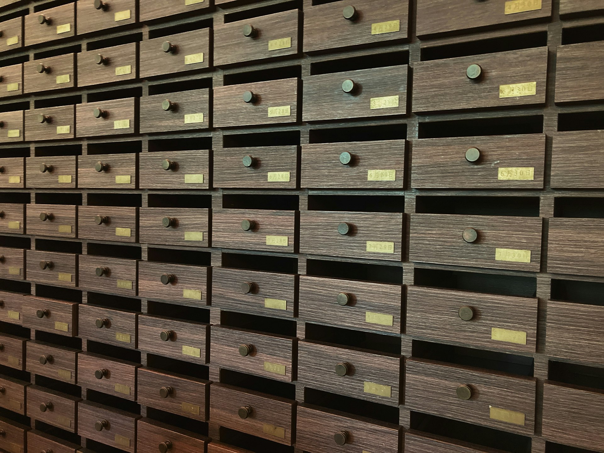A wall full of many drawers in a room